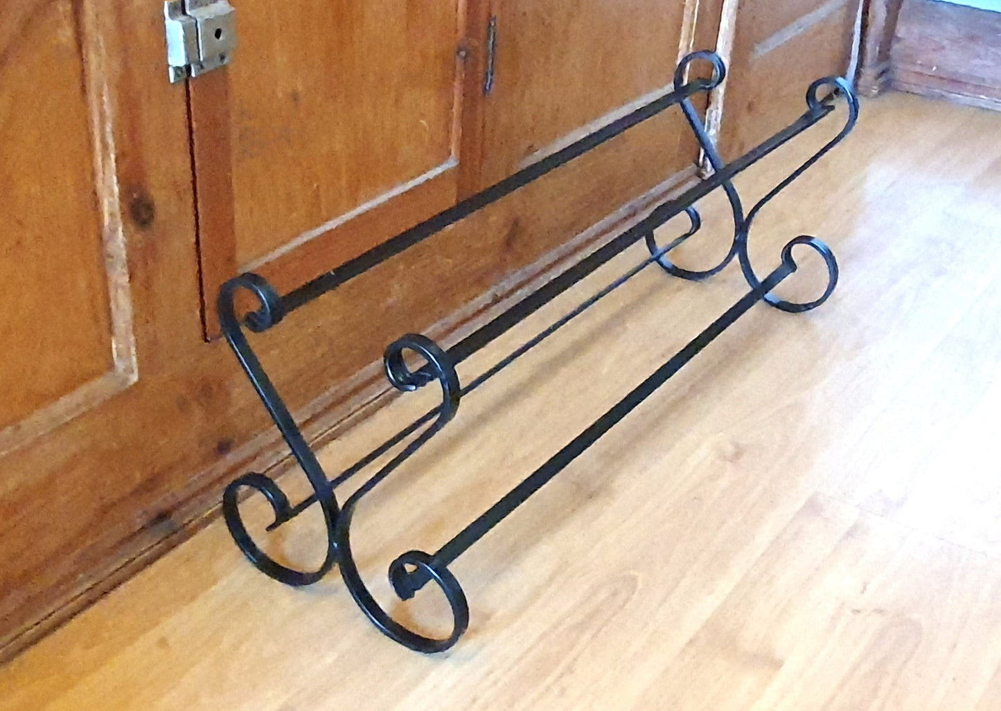 Wrought iron shoe rack. Open topped heart-shape. Handmade and crafted in the UK