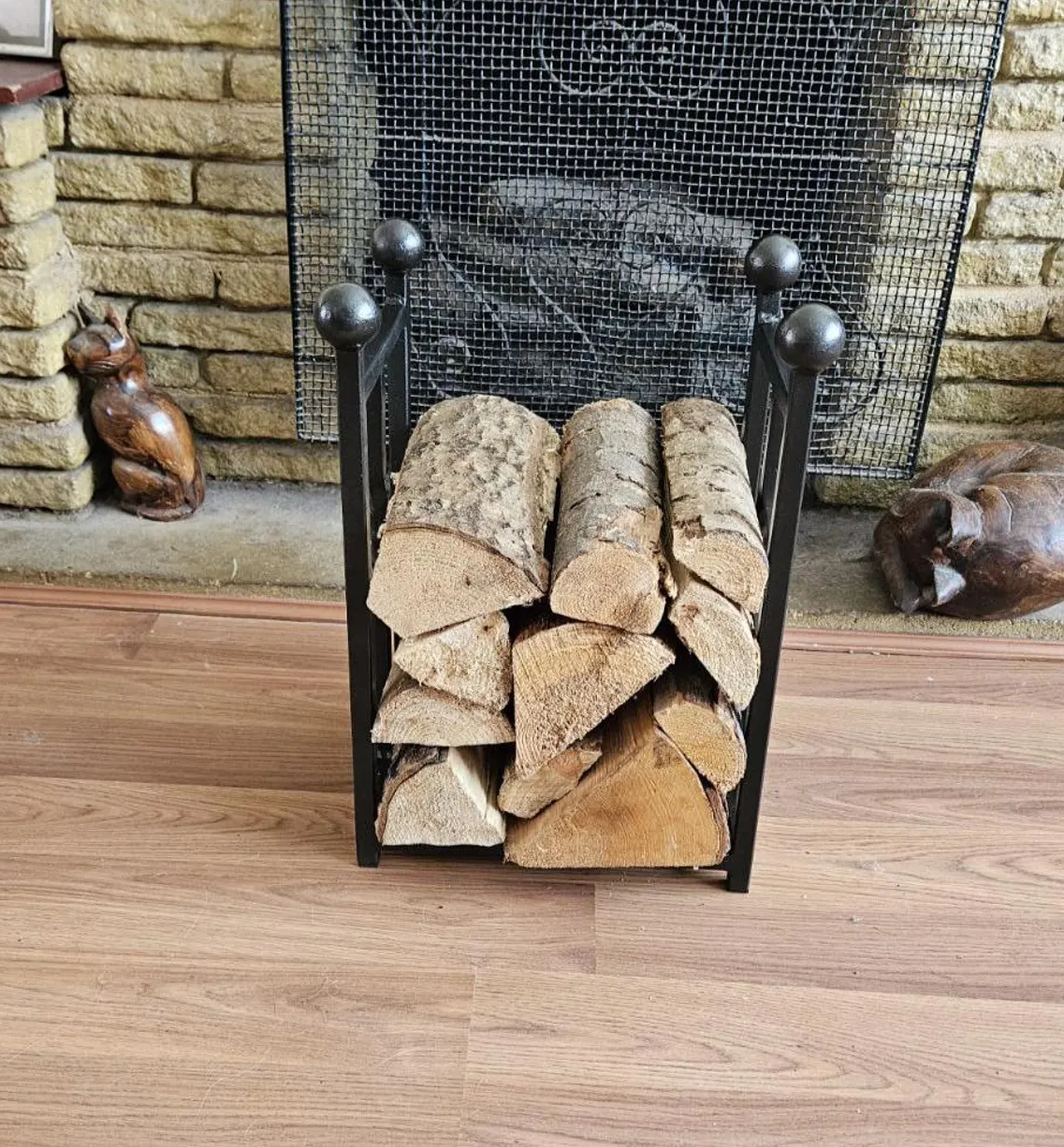 Traditional steel log store with twisted bar detailing. Handmade and crafted in the UK