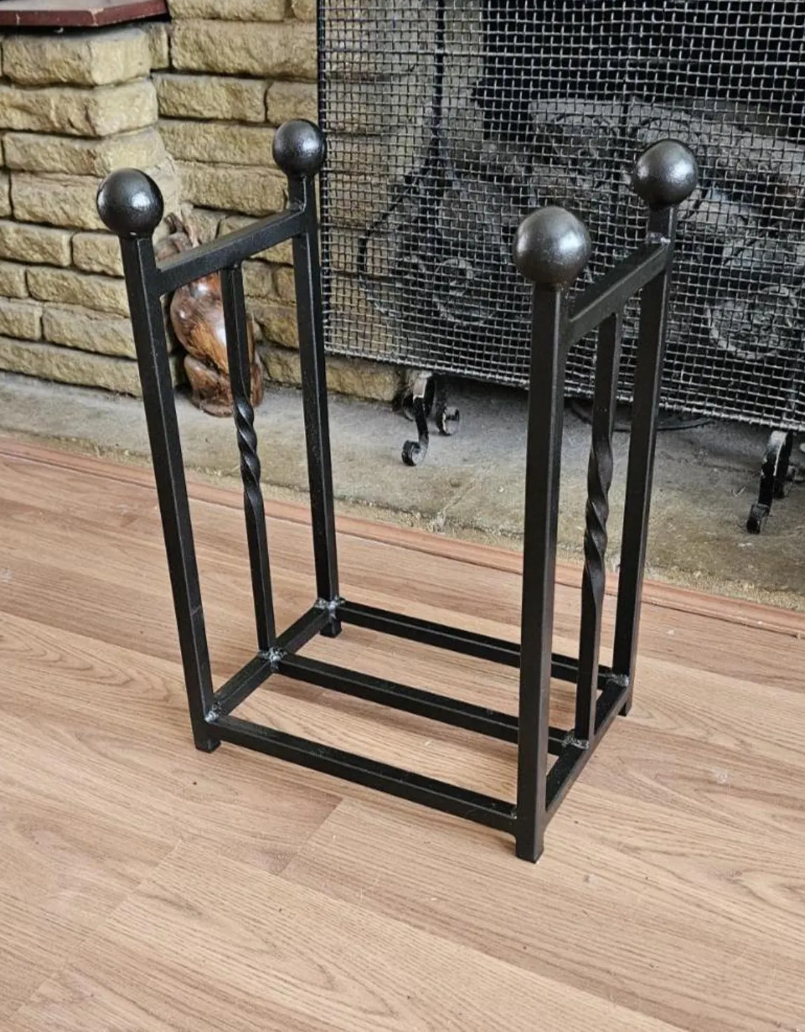 Traditional steel log store with twisted bar detailing. Handmade and crafted in the UK