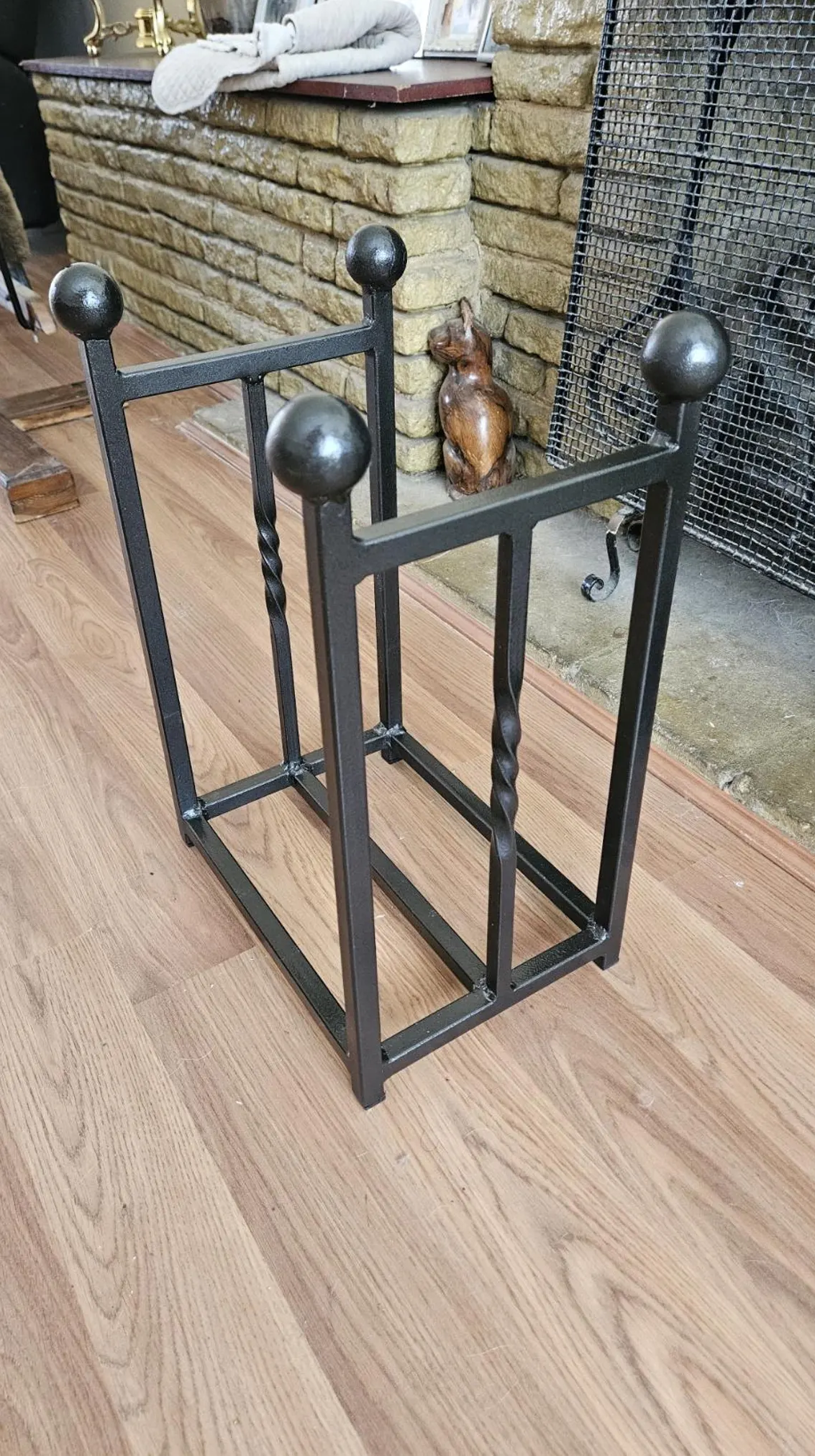 Traditional steel log store with twisted bar detailing. Handmade and crafted in the UK