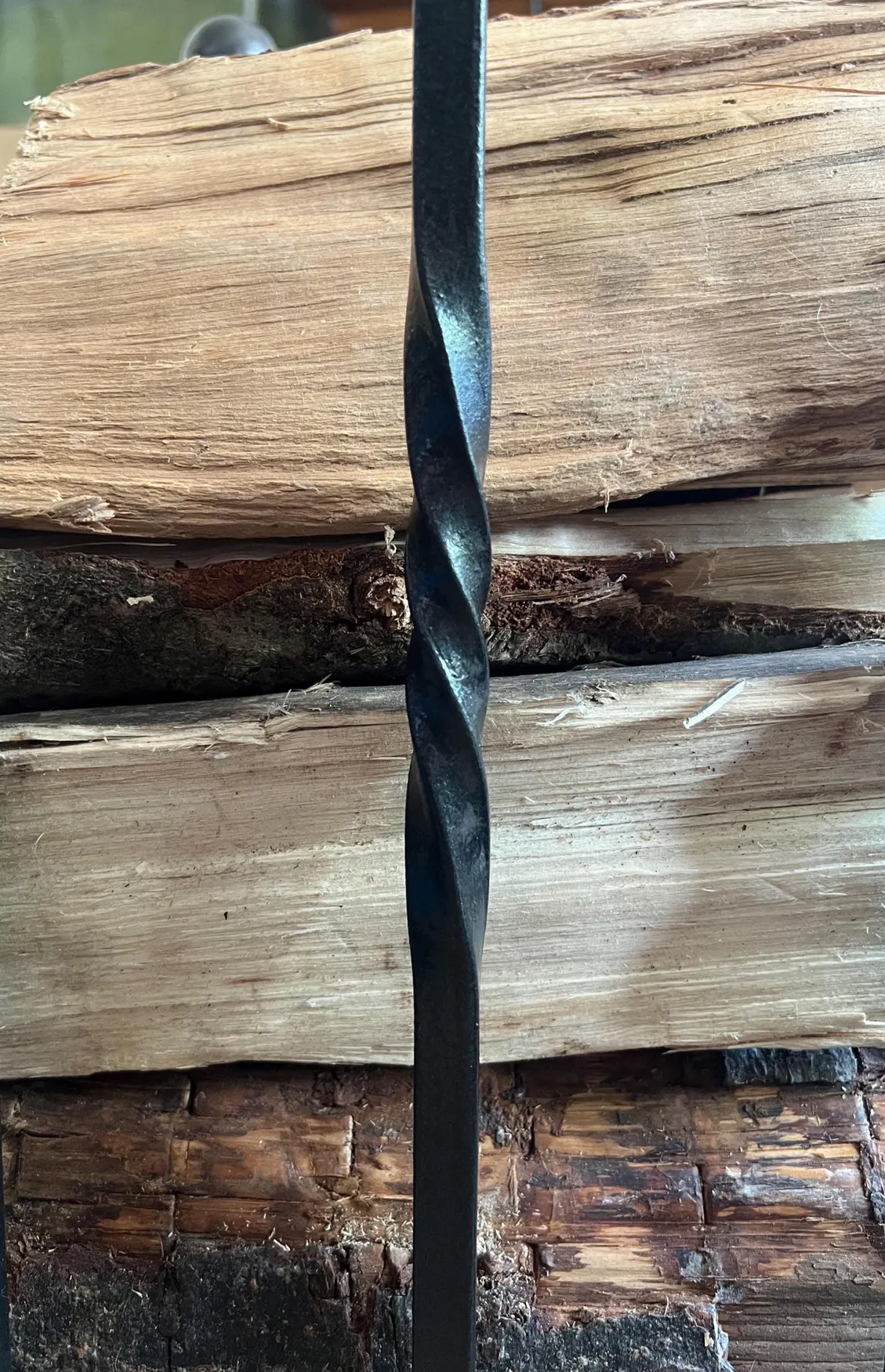 Traditional steel log store with twisted bar detailing. Handmade and crafted in the UK